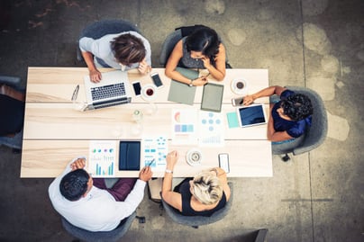 coworkers-seated-at-meeting-table